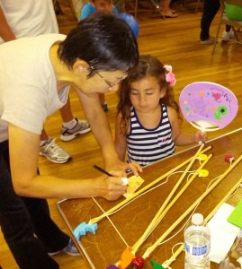 Toshiko-san writes the name of the young fisherman 